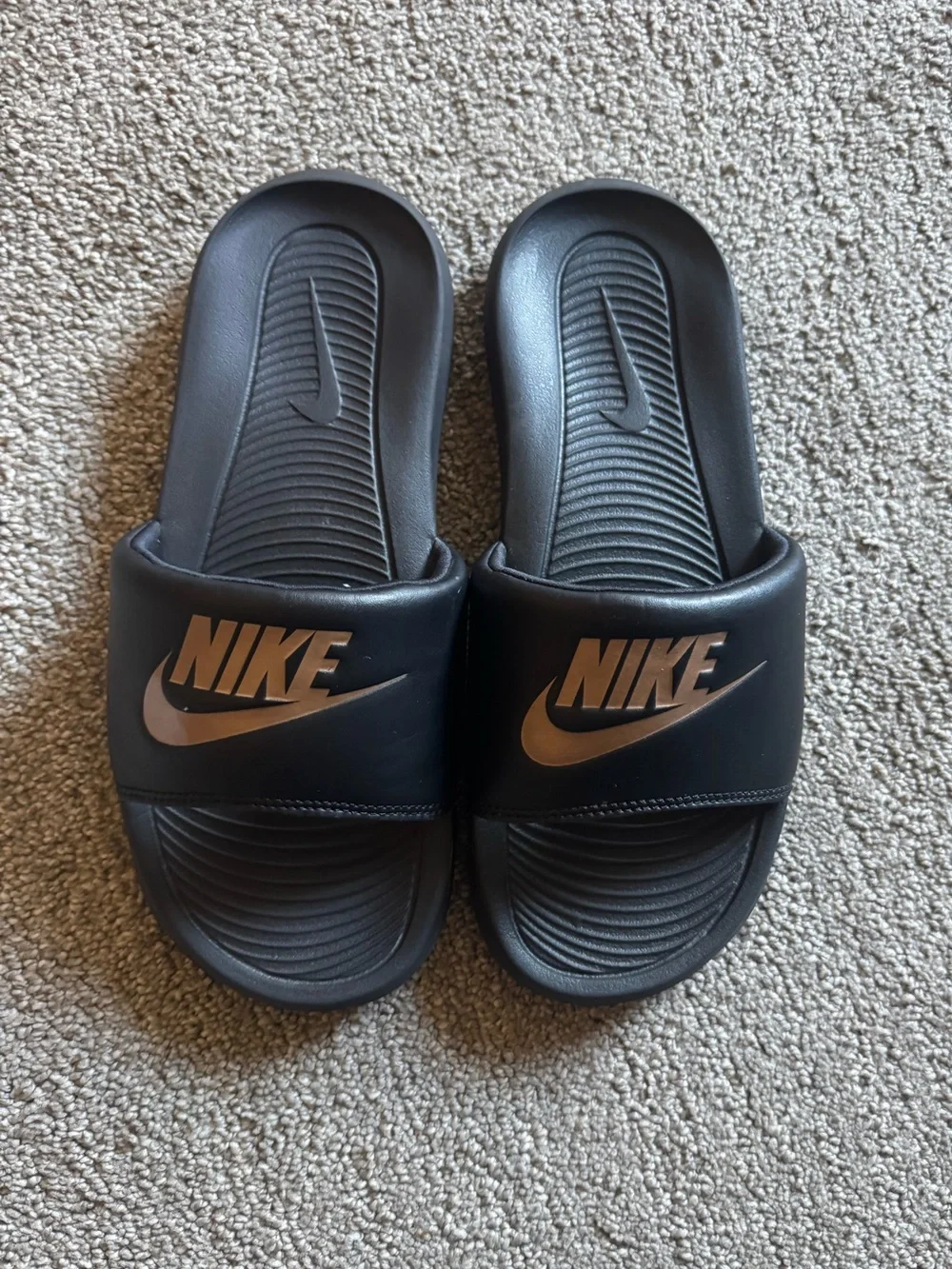 Nike Black Slides with Metallic Bronze Logo